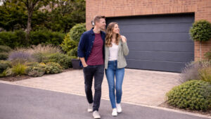 Couple in front of modern garage doors
